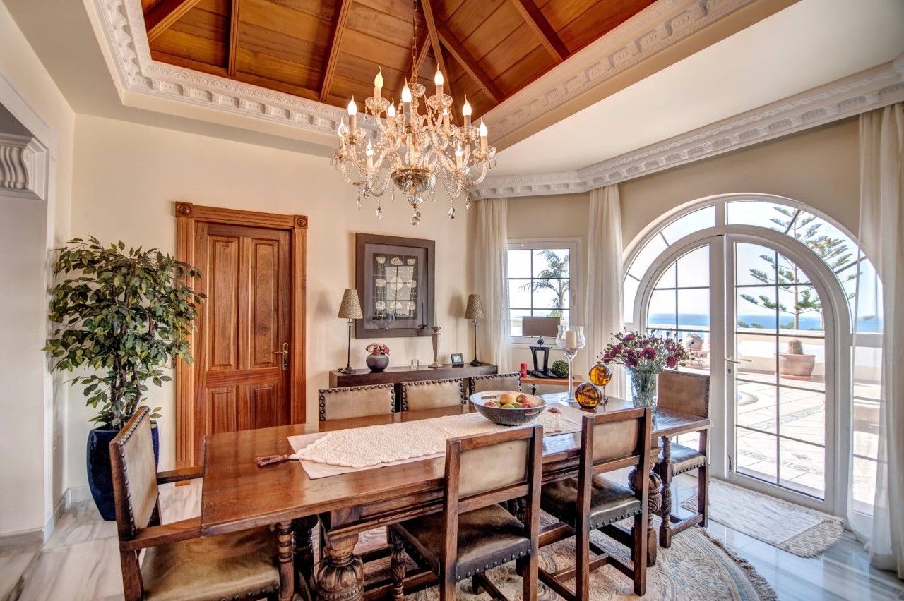 A stylish dining room with high ceilings and large windows, adorned with custom drapes at Heber Valley Blinds near Midway, UT