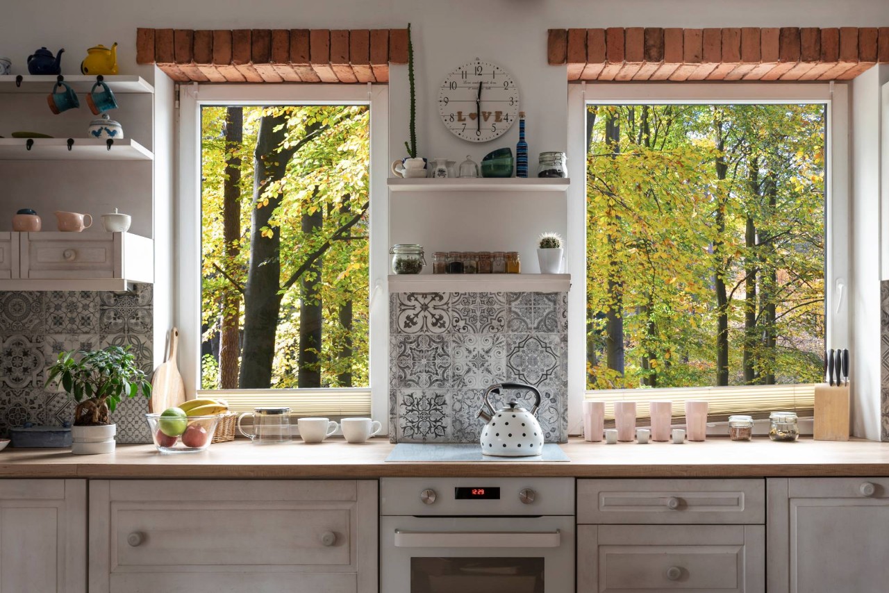 A fancy and elegant kitchen with two windows with a forest view at Heber Valley Blinds near Midway, Utah
